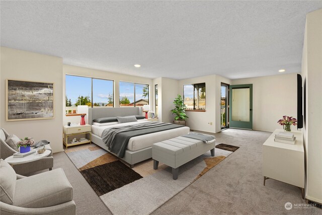 bedroom with light colored carpet and a textured ceiling