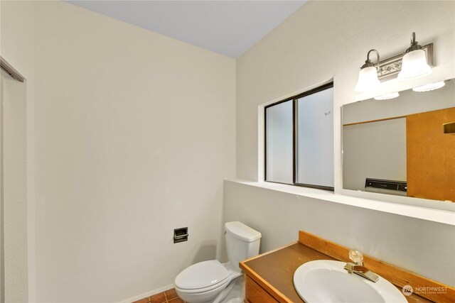 bathroom featuring tile patterned flooring, vanity, and toilet