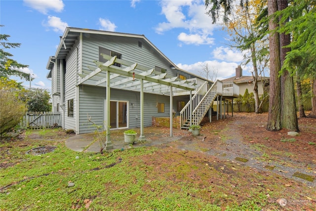 back of property with a pergola