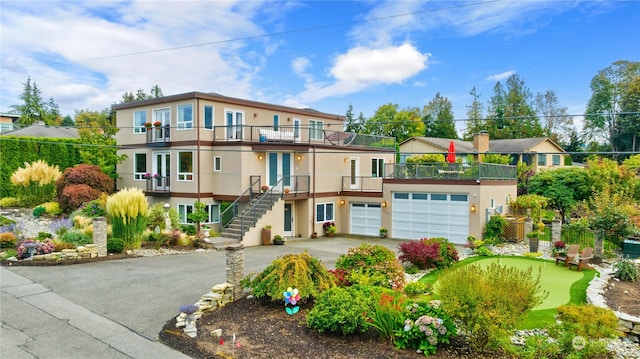 view of front of house with a garage and a balcony