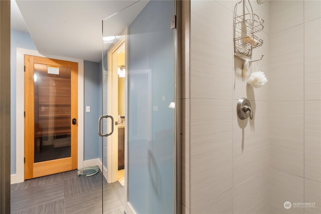 bathroom featuring tile patterned floors and an enclosed shower