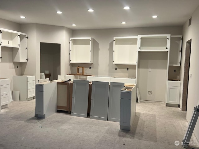 kitchen featuring gray cabinetry and white cabinets