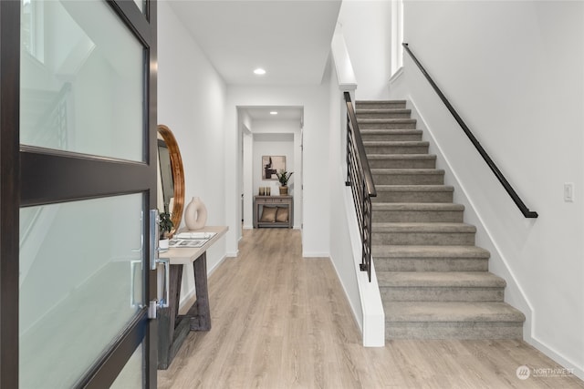 stairs featuring hardwood / wood-style flooring