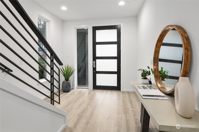 foyer entrance with light hardwood / wood-style floors