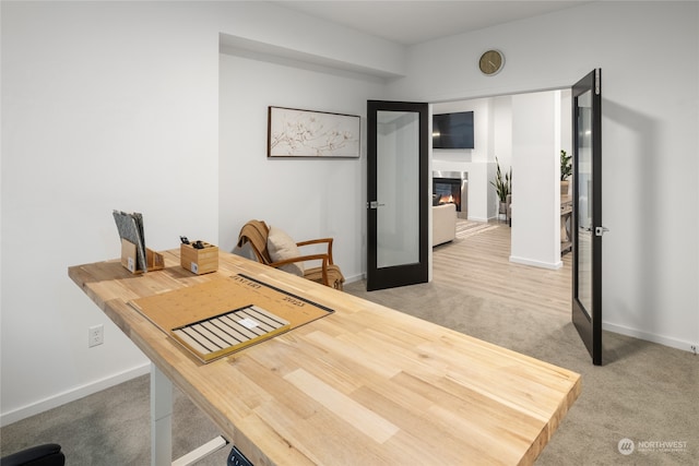 carpeted dining space featuring french doors