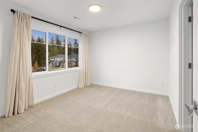 empty room with light colored carpet