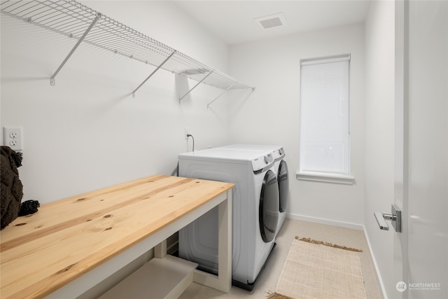 clothes washing area featuring washer and dryer