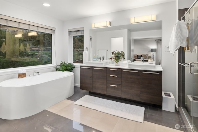 bathroom with plus walk in shower, vanity, and tile patterned floors