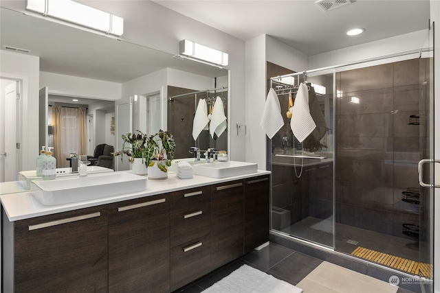 bathroom featuring tile patterned floors, vanity, and walk in shower