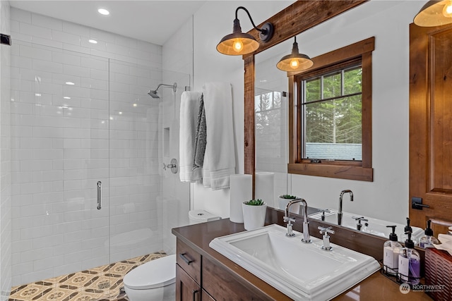 bathroom with toilet, vanity, tile patterned floors, and a shower with door