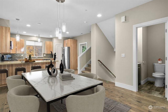 dining area with dark hardwood / wood-style flooring, a healthy amount of sunlight, and sink