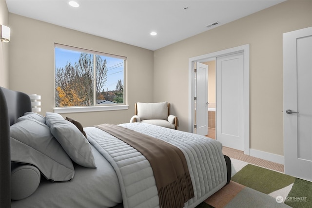 carpeted bedroom featuring connected bathroom