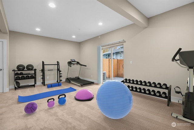 exercise room featuring light carpet