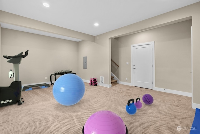 workout room featuring carpet floors and electric panel