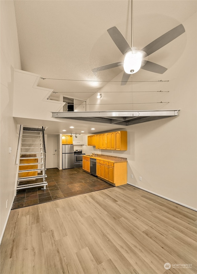 kitchen featuring stainless steel appliances, dark hardwood / wood-style floors, and ceiling fan