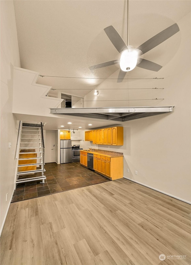 1000 Union St Unit 205, Seattle, WA 98101 - unfurnished living room featuring dark wood-style flooring, stairs, and a ceiling fan