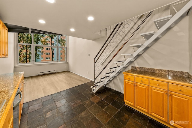 basement with dark wood-type flooring and a baseboard radiator