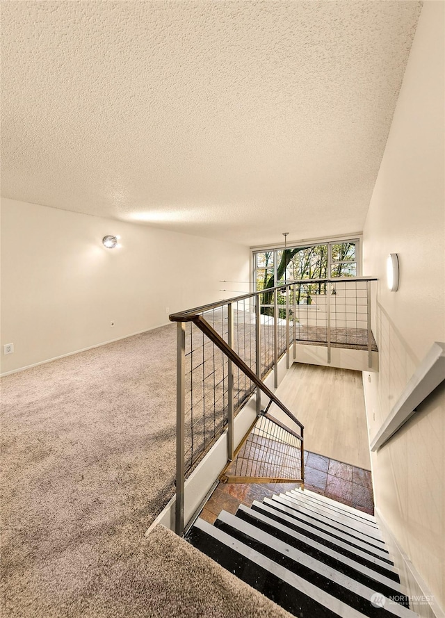 1000 Union St Unit 205, Seattle, WA 98101 - stairway with a textured ceiling, lofted ceiling, and carpet