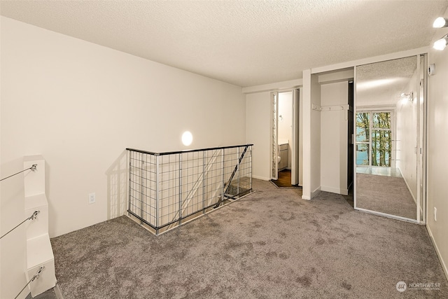 unfurnished bedroom featuring a closet, carpet, and a textured ceiling