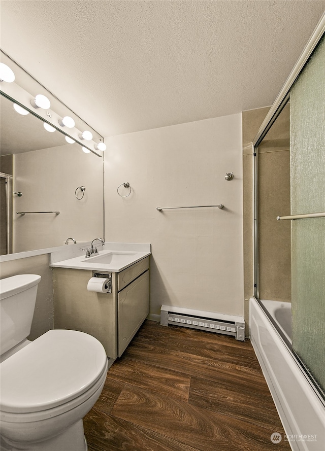 full bathroom featuring a baseboard radiator, wood-type flooring, a textured ceiling, combined bath / shower with glass door, and toilet