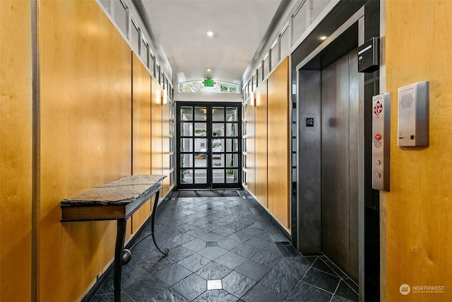 1000 Union St Unit 205, Seattle, WA 98101 - hall featuring french doors, stone tile floors, elevator, lofted ceiling, and recessed lighting