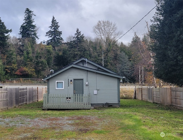 view of outbuilding featuring a yard