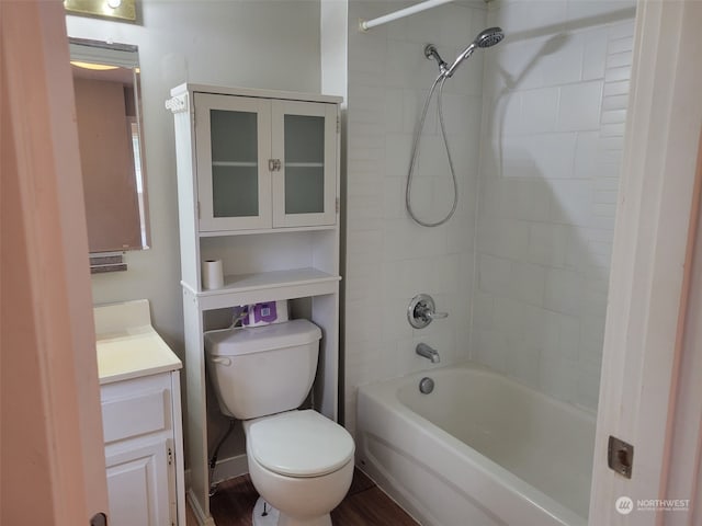 full bathroom featuring vanity, hardwood / wood-style flooring, toilet, and tiled shower / bath combo