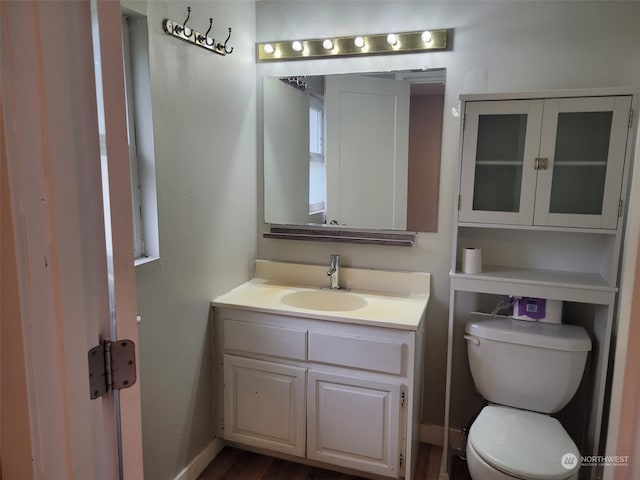 bathroom with vanity, hardwood / wood-style flooring, and toilet