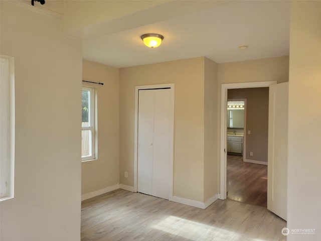 unfurnished bedroom featuring a closet and light hardwood / wood-style flooring