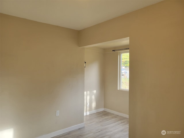 unfurnished room with light wood-type flooring