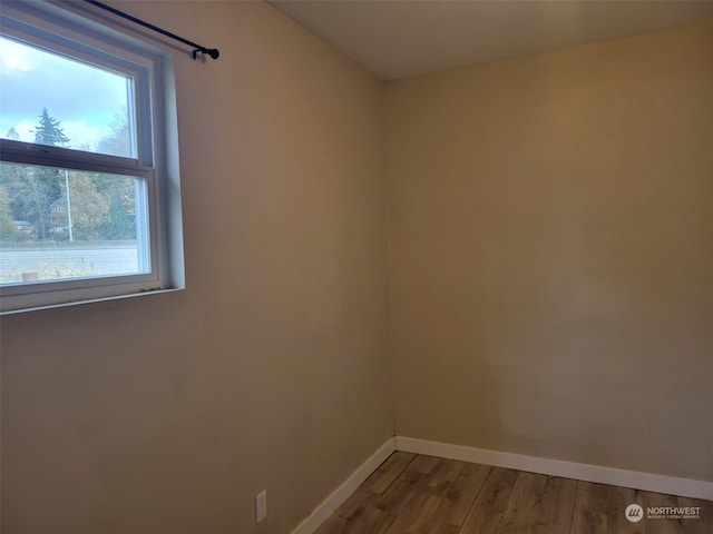 unfurnished room featuring hardwood / wood-style flooring