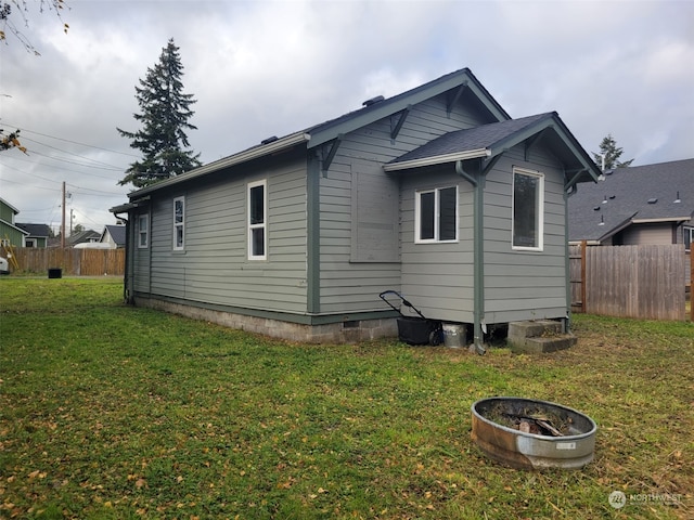 rear view of house with a yard