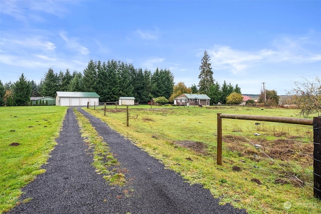 view of yard featuring an outbuilding and a rural view