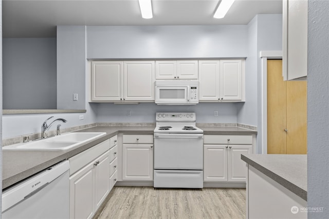 kitchen featuring white cabinetry, white appliances, sink, and light hardwood / wood-style floors