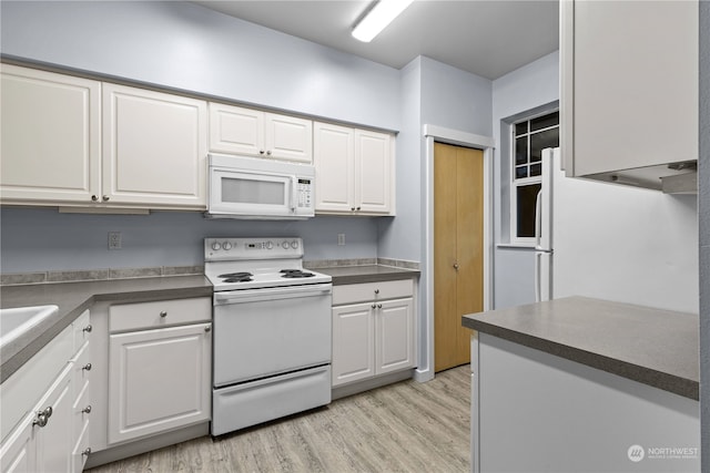 kitchen featuring light wood-type flooring, white appliances, and white cabinets