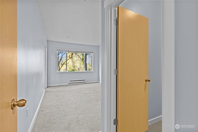 corridor featuring light carpet and a baseboard heating unit