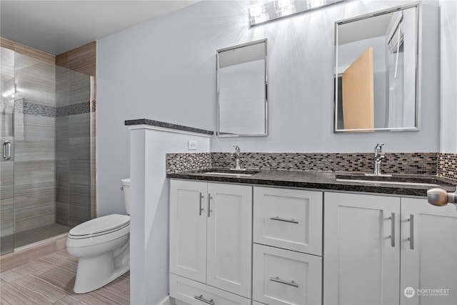 bathroom featuring walk in shower, tile patterned flooring, vanity, and toilet