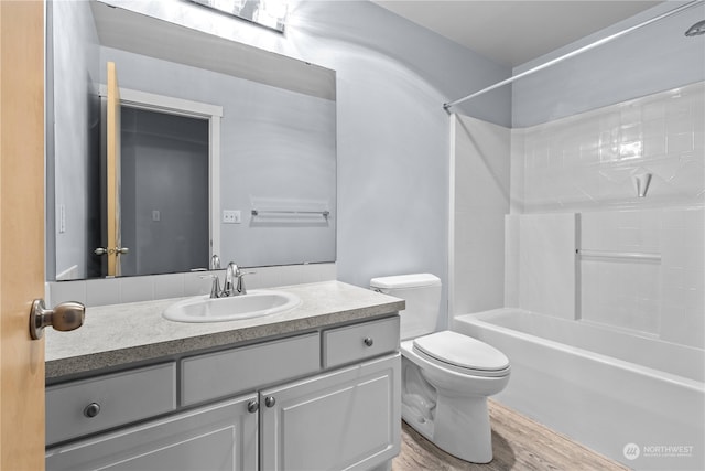 full bathroom with vanity, hardwood / wood-style flooring, toilet, and bathtub / shower combination