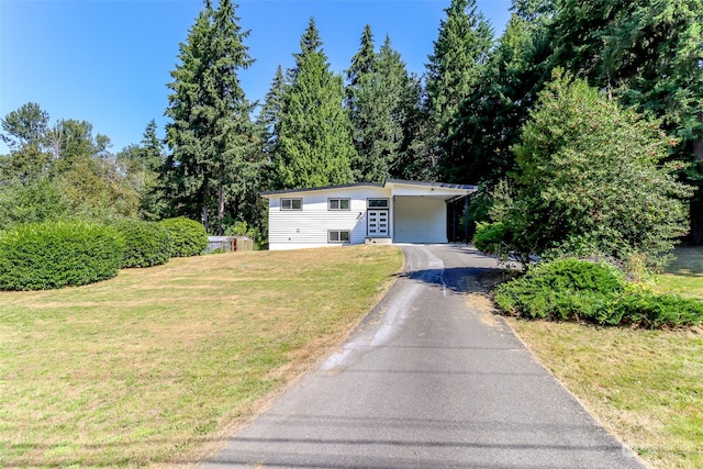 view of front facade with a carport and a front lawn