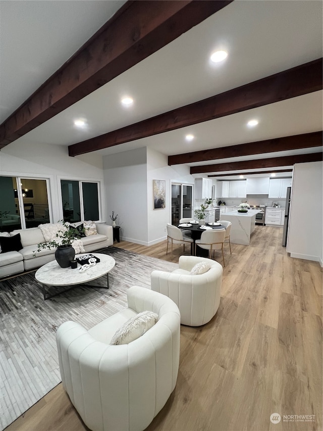 living room featuring light hardwood / wood-style flooring and beamed ceiling