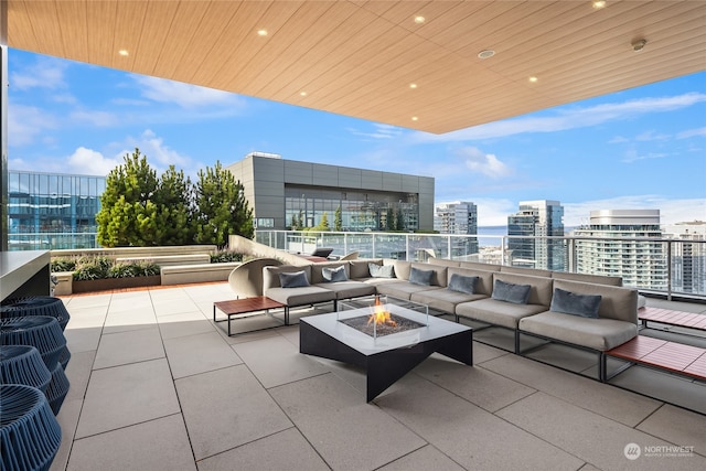 view of patio featuring an outdoor living space with a fire pit