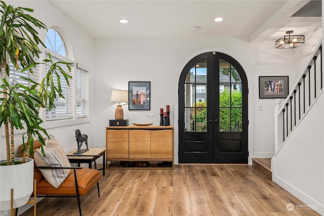 foyer featuring french doors and light hardwood / wood-style floors