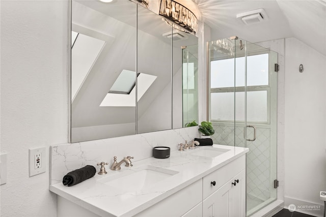 bathroom with vanity, an enclosed shower, lofted ceiling with skylight, and tasteful backsplash