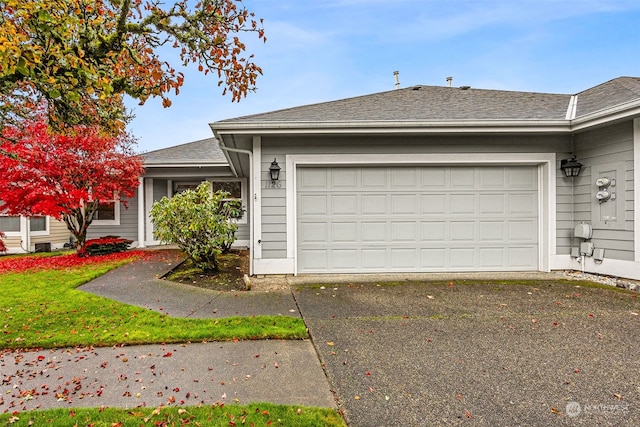 ranch-style home with a garage and a front yard