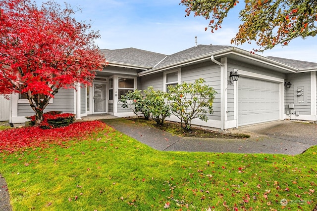 view of front of property featuring a garage and a front yard