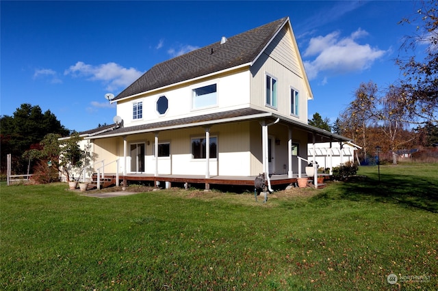 rear view of property featuring covered porch and a yard