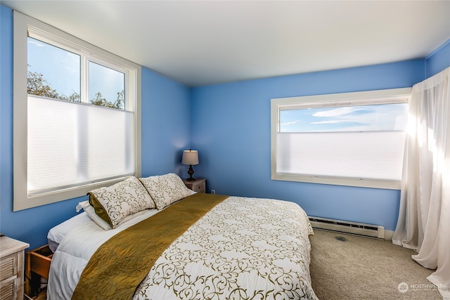 bedroom with carpet and a baseboard heating unit