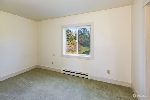 carpeted spare room with a baseboard radiator