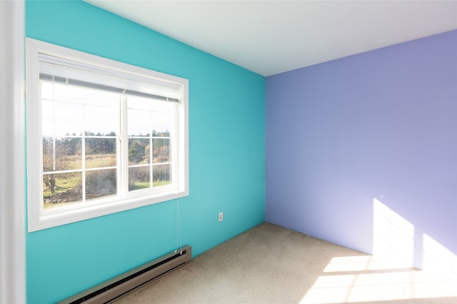 unfurnished room featuring baseboard heating and light carpet