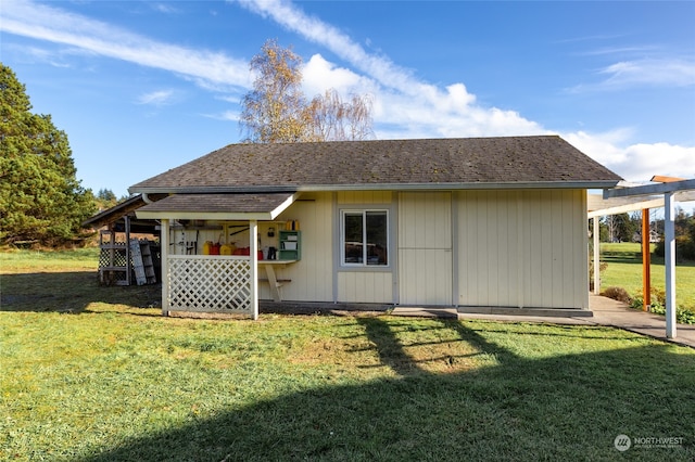 rear view of house featuring a yard